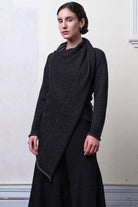 Model wears knitted merino cross over,  in black and charcoal colourway.