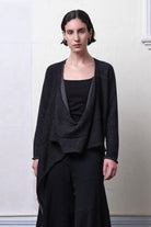 Model wears knitted merino cross over, undone in black and charcoal colourway.