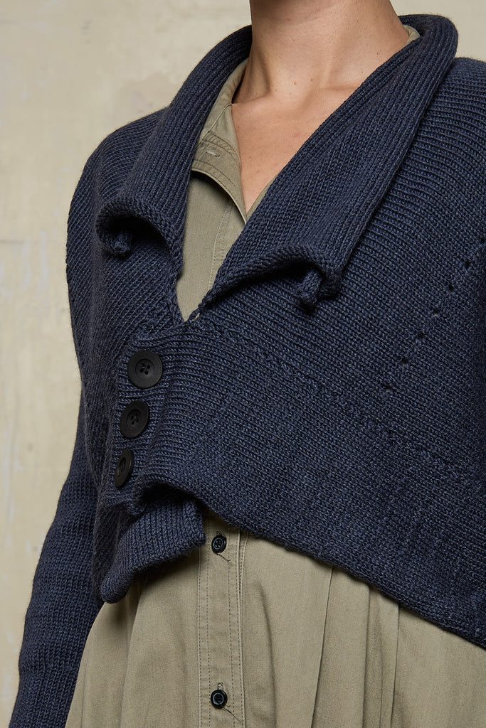 Close up fabric view of Chunky Knit Cardigan design by Wendy Voon in charcoal blue superfine merino wool with black buttons worn buttoned