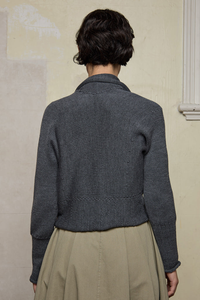 Back view of Chunky Knit Cardigan design by Wendy Voon in steel grey superfine merino wool with black buttons.