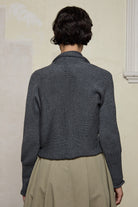 Back view of Chunky Knit Cardigan design by Wendy Voon in steel grey superfine merino wool with black buttons.