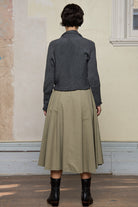 Back view of Chunky Knit Cardigan design by Wendy Voon in steel grey superfine merino wool with black buttons.