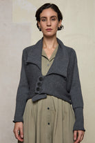 Front view of Chunky Knit Cardigan design by Wendy Voon in steel grey superfine merino wool with black buttons worn buttoned.
