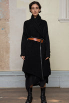 Model wears black knitted coat belted, made from alpaca and superfine merino wool. Designed and made in Melbourne by Wendy Voon Knits