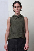 Model wears army linen/cotton laddered vest back to front. Designed and knitted in Melbourne by Wendy Voon knits.