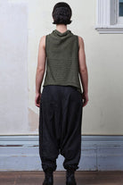 Model wears army linen/cotton laddered vest. Designed and knitted in Melbourne by Wendy Voon knits.