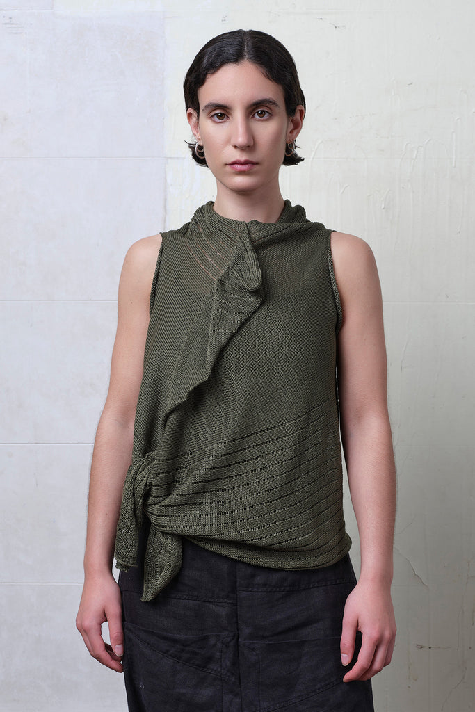 Model wears army linen laddered vest, cinched at the waist. Designed and knitted in Melbourne by Wendy Voon knits.