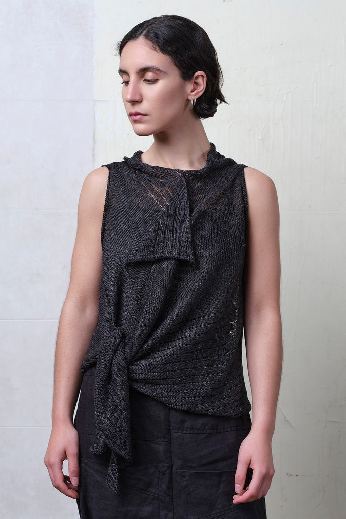 Model wears charcoal linen laddered vest cinched at the waist. Designed and knitted in Melbourne by Wendy Voon knits.