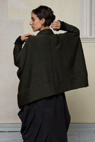 Back view of box shaped jumper designed by Wendy Voon, in an army with black backed fabric, made from superfine merino wool.