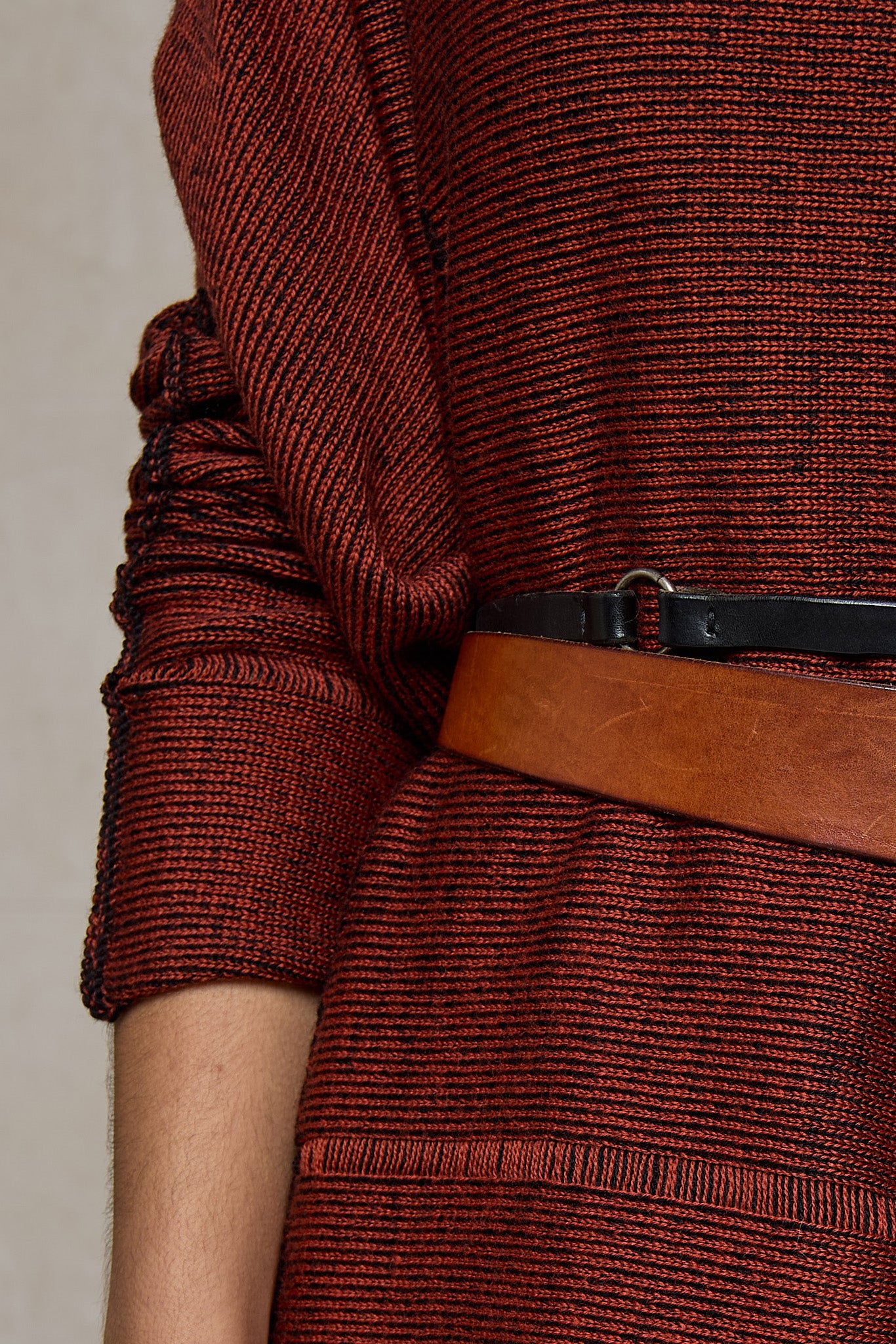 Close up fabric view of box shaped jumper designed by Wendy Voon, in a vermillion with black backed fabric. Made from superfine merino wool.