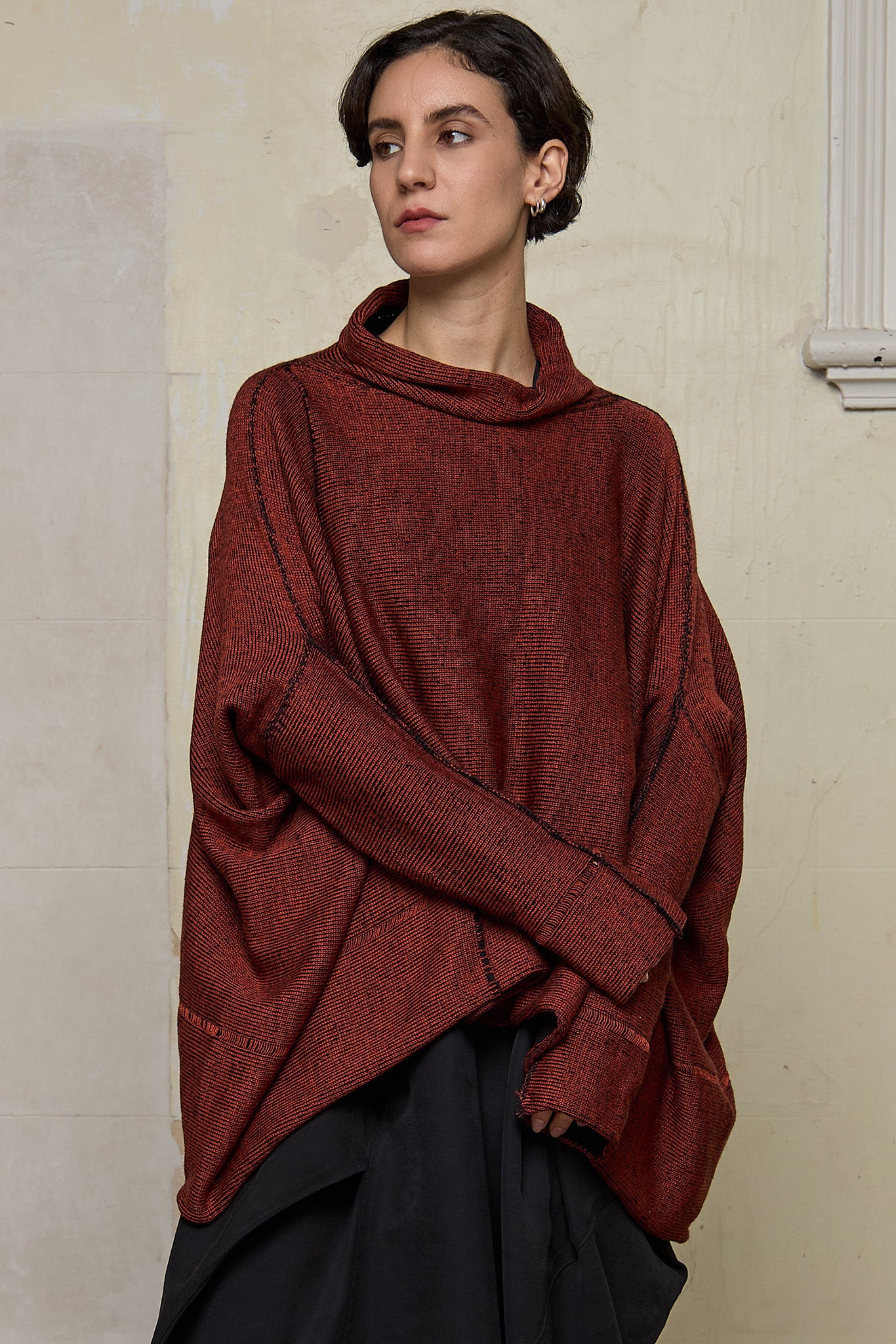 Front view of box shaped jumper designed by Wendy Voon, in a vermillion with black backed fabric. Made from superfine merino wool.
