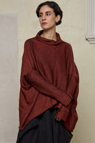 Front view of box shaped jumper designed by Wendy Voon, in a vermillion with black backed fabric. Made from superfine merino wool.