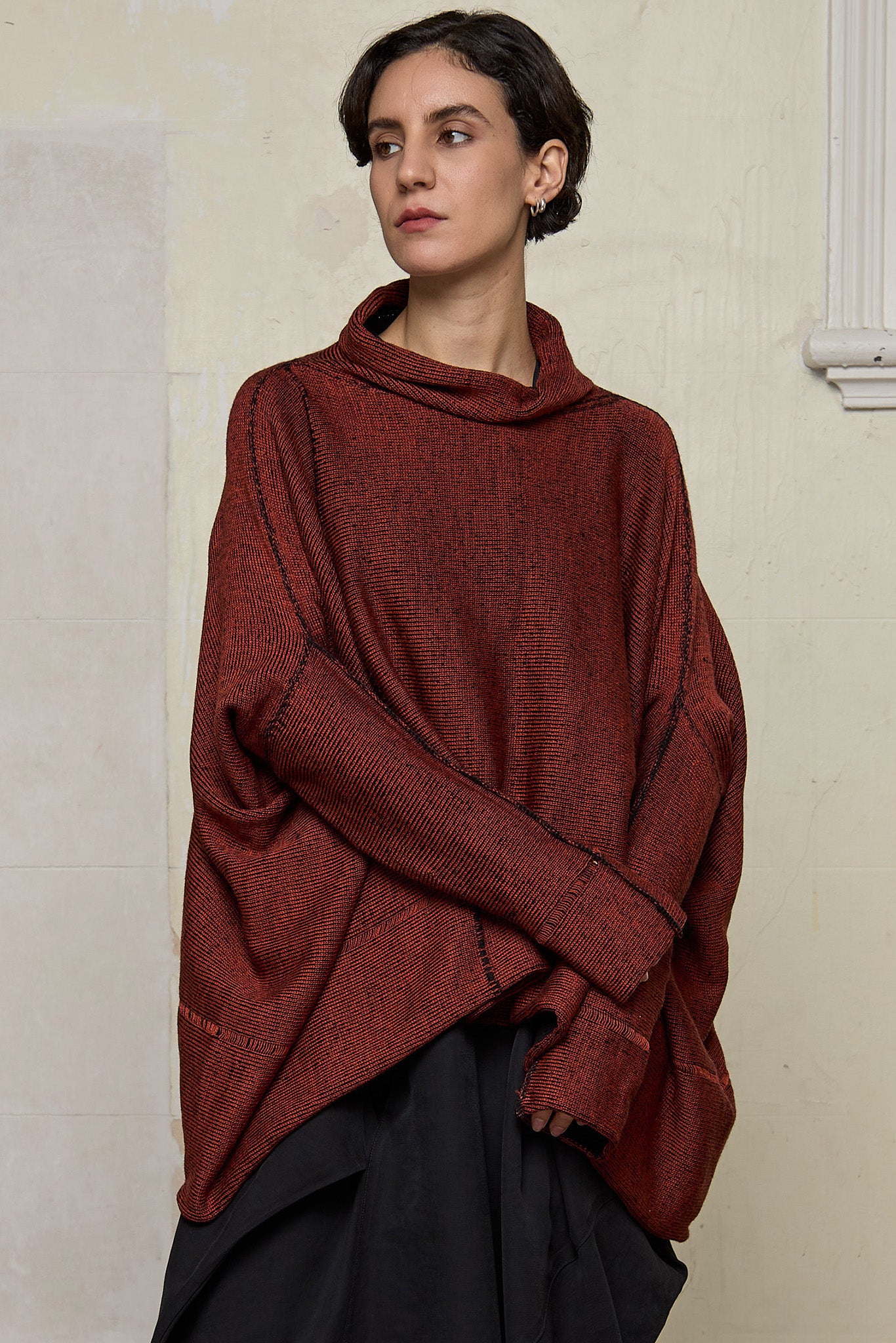 Front view of box shaped jumper designed by Wendy Voon, in a vermillion with black backed fabric. Made from superfine merino wool.