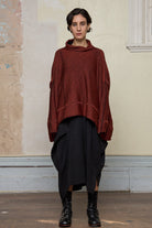 Front view of box shaped jumper designed by Wendy Voon, in a vermillion with black backed fabric. Made from superfine merino wool.