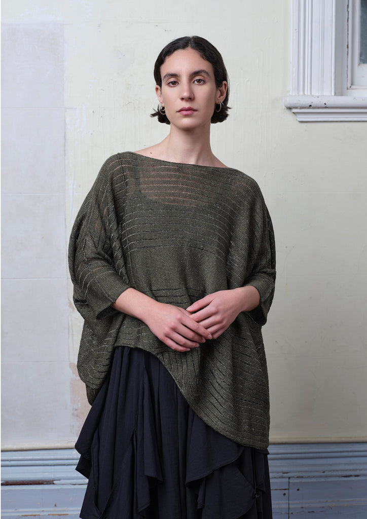 Model wears linen/cotton knitted tulip top in army backed with black/white flecked colourway. Designed and knitted in Melbourne by Wendy Voon knits.