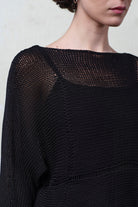 Close up front view of model wearing Cotton Batwing  in black colourway, featuring lace details along garment seam,  designed by Wendy Voon knits.