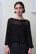 Front view of model wearing Cotton Batwing  in black colourway, featuring lace details along garment seam,  designed by Wendy Voon knits.