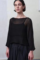 Front view of model wearing Cotton Batwing  in black colourway, featuring lace details along garment seam,  designed by Wendy Voon knits.