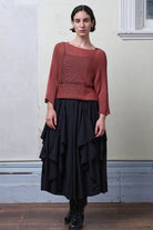 Front view of model wearing Cotton Batwing  in coral colourway, featuring large stitch details,  designed by Wendy Voon knits.
