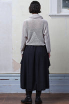 Back view of model wearing pearl coloured knitted back scoop jumper in a cotton/linen blend. Designed and knitted in Melbourne by Wendy Voon knits.