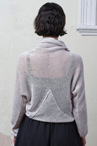 Back view of model wearing pearl coloured knitted back scoop jumper in a cotton/linen blend. Designed and knitted in Melbourne by Wendy Voon knits.