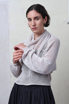 Model wears pearl coloured knitted back scoop jumper in a cotton/linen blend. Designed and knitted in Melbourne by Wendy Voon knits.