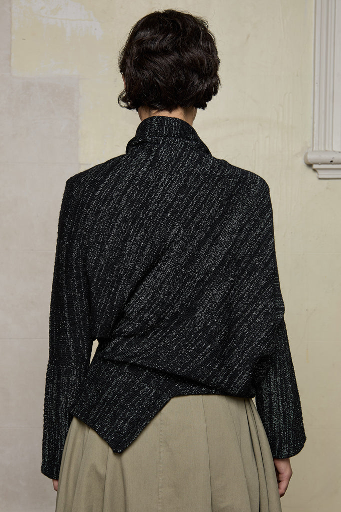 Back view of Bias jumper, a design by Wendy Voon knits in a black flecked with white merino wool and linen/cotton blend fabric. 
