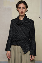 Front view of Bias jumper, a design by Wendy Voon knits in a black flecked with white merino wool and linen/cotton blend fabric. 