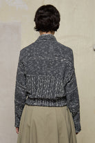 Back view of grey flecked chunky knit cardigan, with ruched detail, worn upside down.  Designed and made by Wendy Voon knits