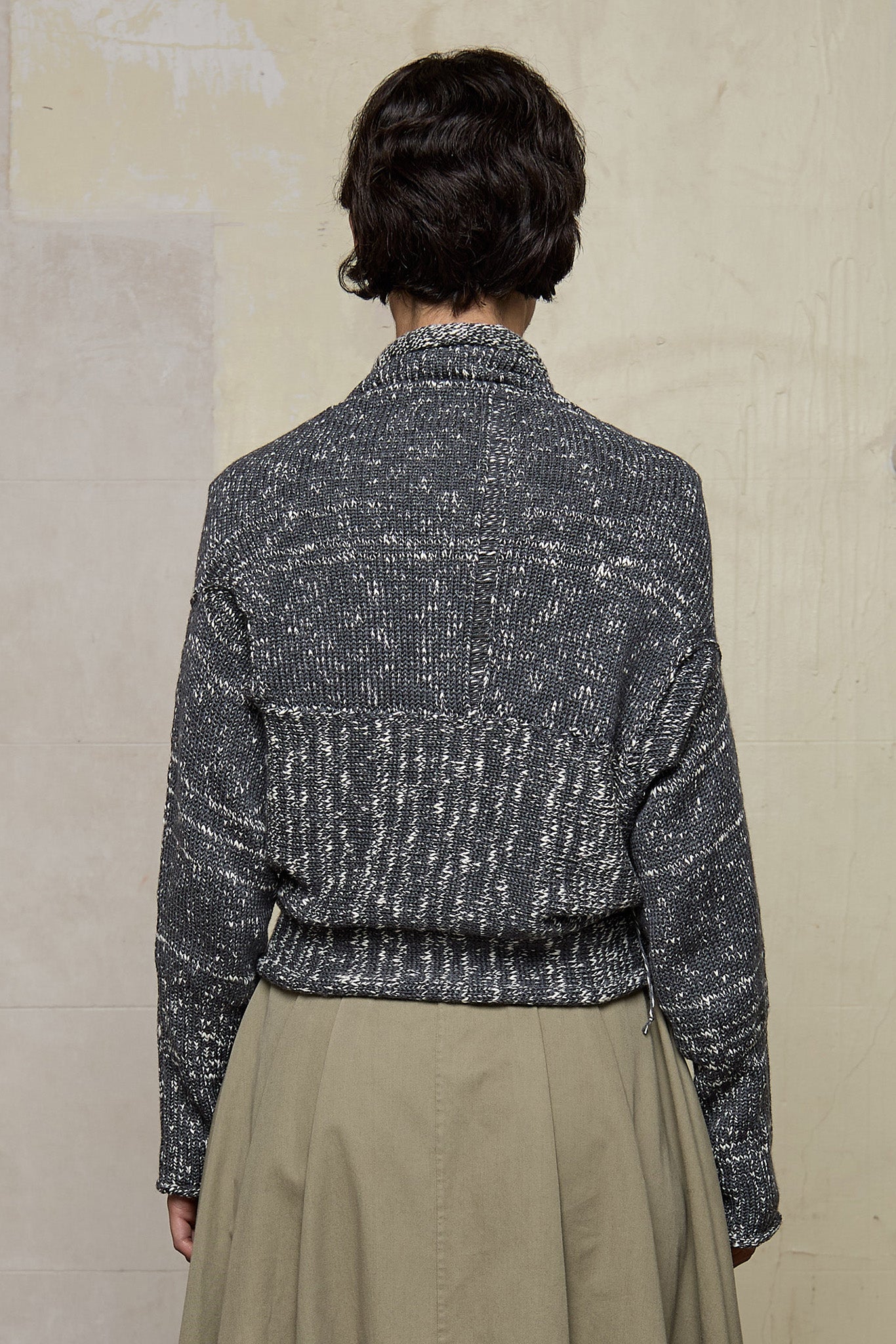 Back view of grey flecked chunky knit cardigan, with ruched detail, worn upside down.  Designed and made by Wendy Voon knits