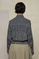 Back view of grey flecked chunky knit cardigan, with ruched detail, worn upside down.  Designed and made by Wendy Voon knits