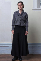 Front full body view of model wearing a chunky knit wool ruched cardigan in a grey with white flecked colourway.