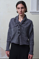 Front view of model wearing a chunky knit wool ruched cardigan in a grey with white flecked colourway.
