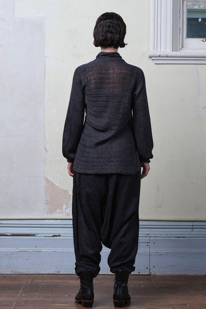 Back view of model wearing cotton laddered knitted jumper in slate, designed and knitted in Melbourne by Wendy Voon knits.