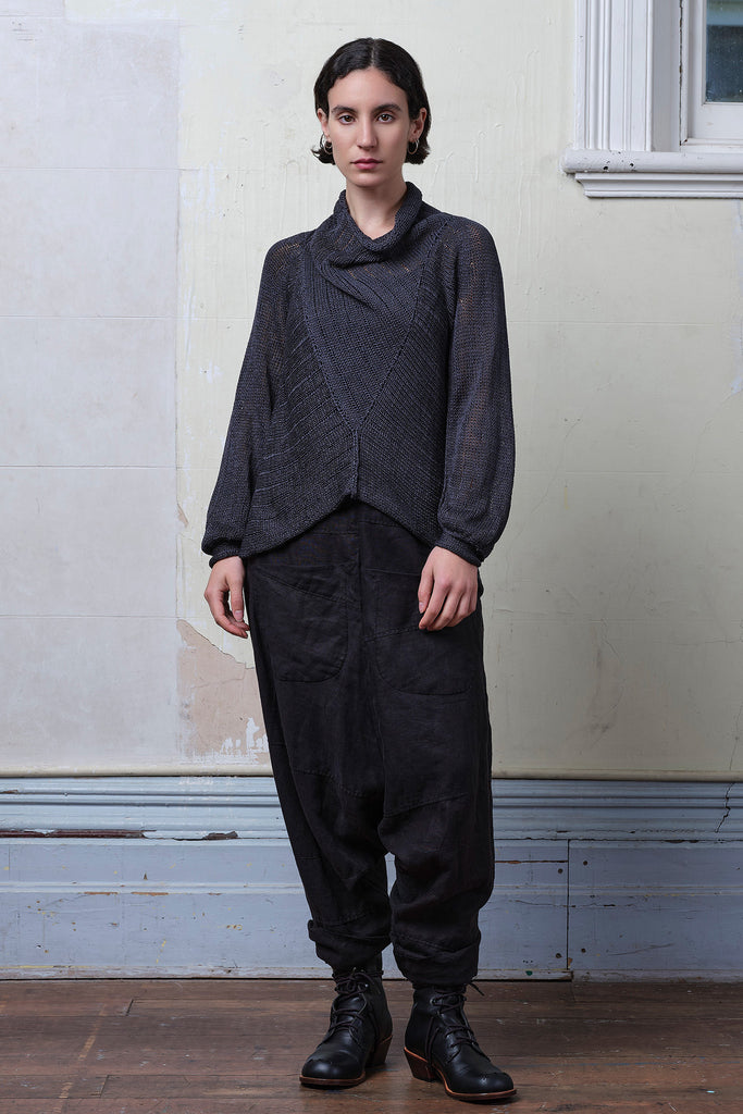 Model wears cotton laddered knitted jumper in slate, designed and knitted in Melbourne by Wendy Voon knits.