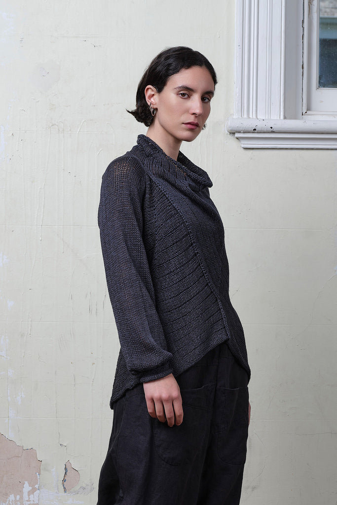 Model wears cotton laddered knitted jumper in slate, designed and knitted in Melbourne by Wendy Voon knits.