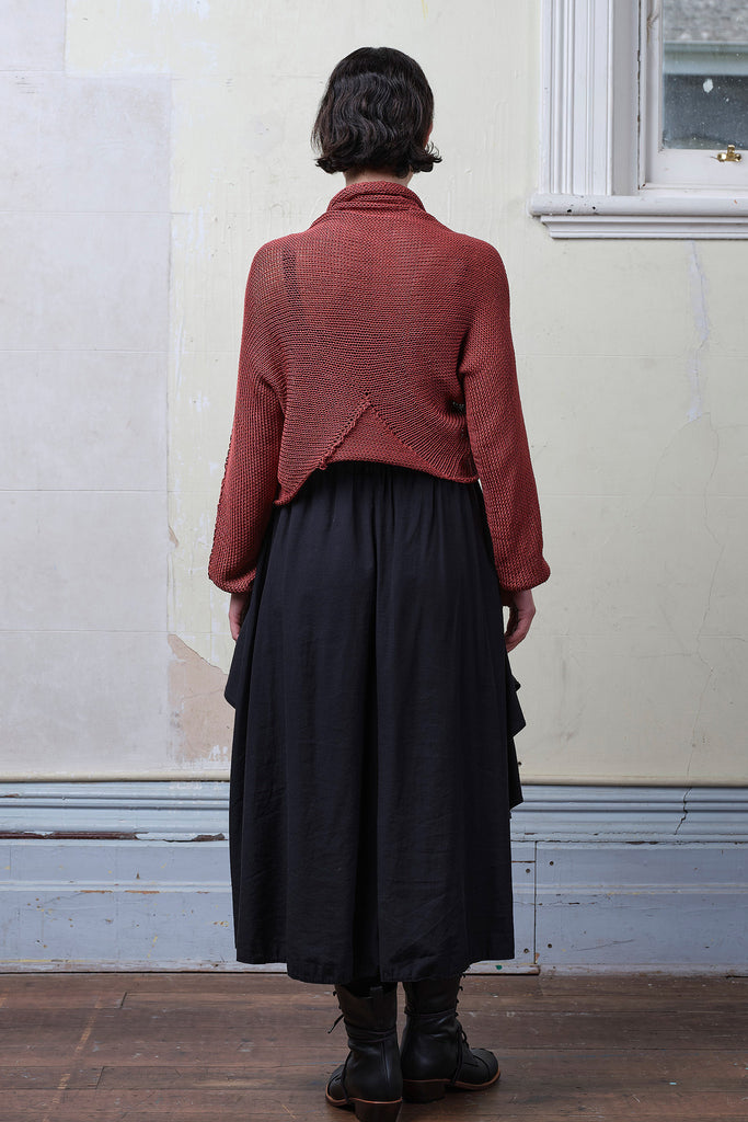 Back view of model wearing coral cotton cropped jumper. Designed and knitted in Melbourne by Wendy Voon knits