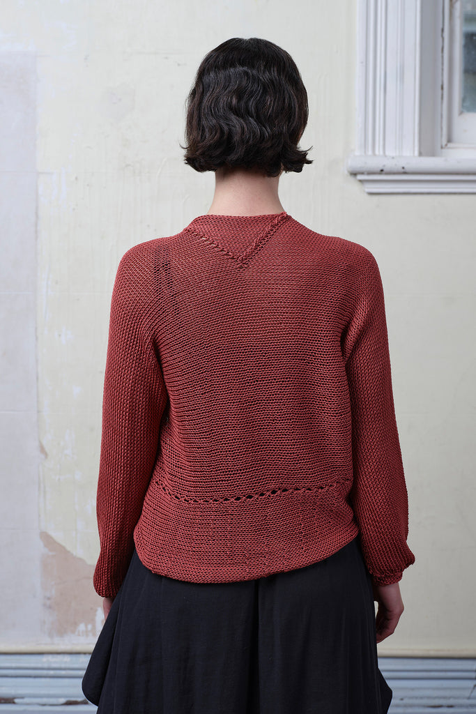 Back view of model wearing coral cotton cropped jumper upside down. Designed and knitted in Melbourne by Wendy Voon knits