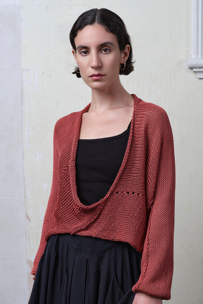 Model wears coral cotton cropped jumper upside down. Designed and knitted in Melbourne by Wendy Voon knits