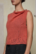 Side view of model wearing super lush knitted vest in carrot colourway, designed and knitted in Melbourne by Wendy Voon knits 