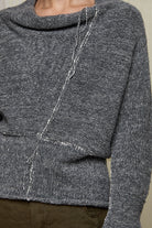 Close up fabric view of wool boucle knitted jumper in grey melange with decorative external seam details.