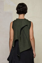 Model wears knitted asymmetric vest back to front, in army on black colour way. Designed and knitted in Melbourne by Wendy Voon knits