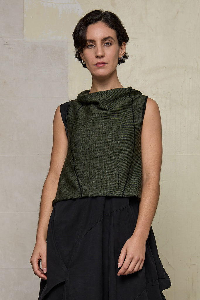 Model wears knitted asymmetric vest back to front, in army on black colour way. Designed and knitted in Melbourne by Wendy Voon knits.