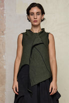Model wears knitted asymmetric self-curling vest, in army green on black colourway. Designed and knitted in Melbourne by Wendy Voon knits.