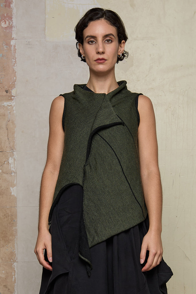 Model wears knitted asymmetric self-curling vest, in army green on black colourway. Designed and knitted in Melbourne by Wendy Voon knits.