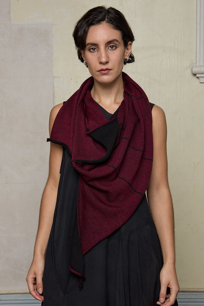 Model wears knitted asymmetric self-curling vest as a scarf, in burgundy on black colourway. Designed and knitted in Melbourne by Wendy Voon knits