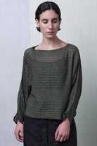 Model wears linen/cotton batwing in army backed with black and white flecked colourway. Designed and knitted in Melbourne  by Wendy Voon knits