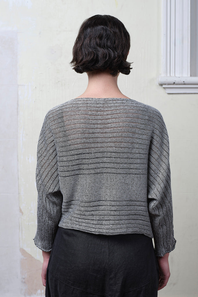 Model wears linen/cotton batwing in silver grey backed with black colourway. Designed and knitted in Melbourne  by Wendy Voon knits