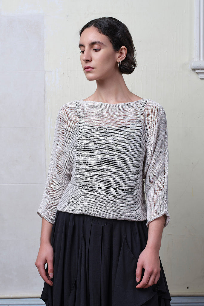 Model wears an open knitted linen/cotton batwing jumper in pearl colourway, designed and knitted in Melbourne by Wendy Voon knits.