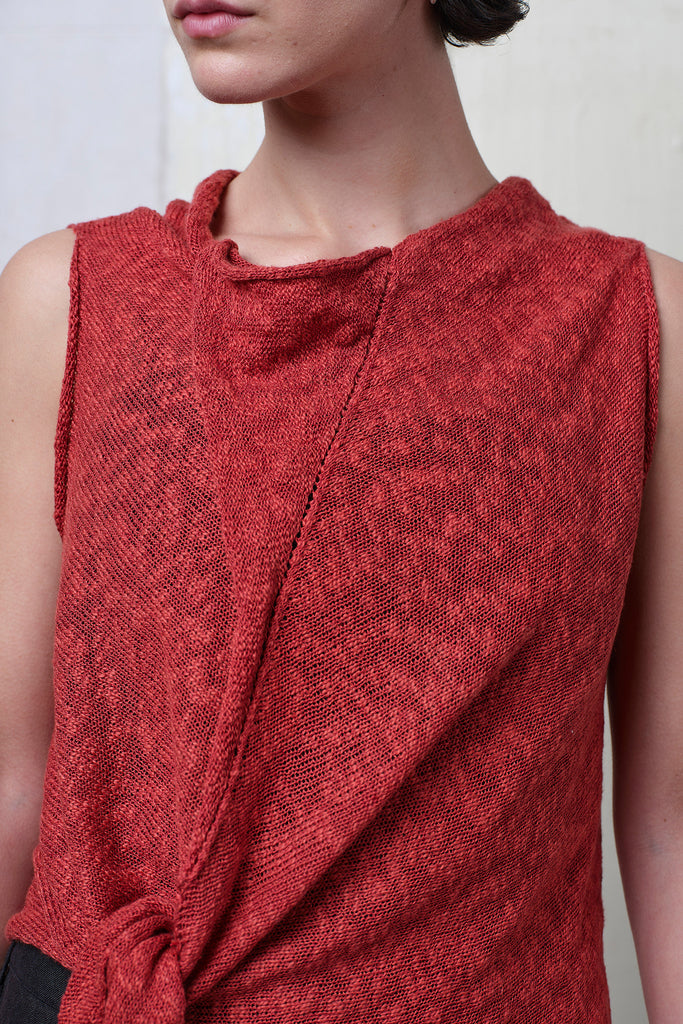 Model wears textured cotton/linen self curling vest in coral colourway. Designed and knitted in Melbourne, by Wendy Voon knits.